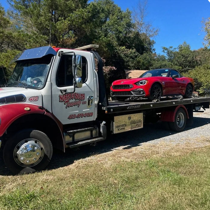Car Towing Service North and South Towing Cleveland Tennessee Red Car on Flatbed Tow Truck