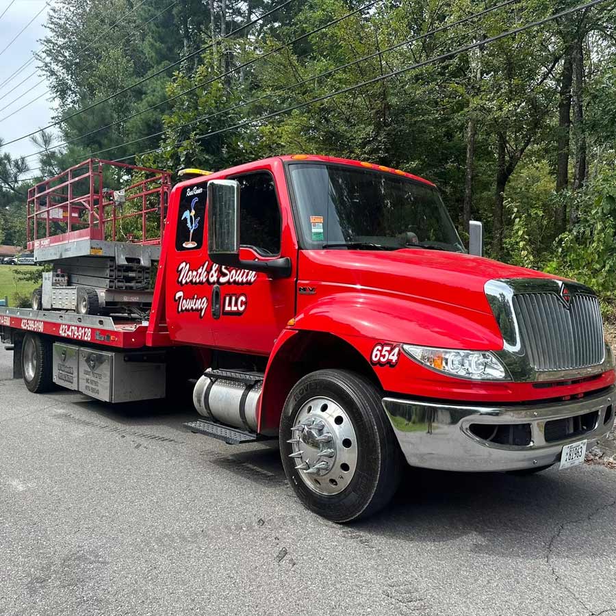 North and South Towing LLC Flatbed Tow Truck Transporting Scissor Lift Cleveland Tennessee